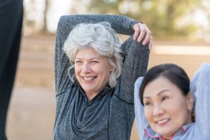 Senior Best friends Stretching Outside Senior Best friends Stretching Outside